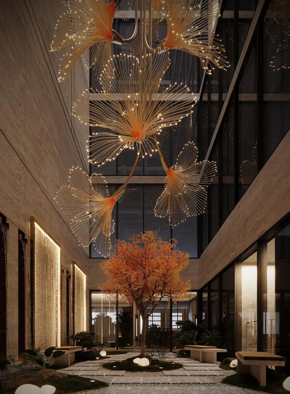 Open-to-sky courtyard with a sculptural tree and suspended light installation