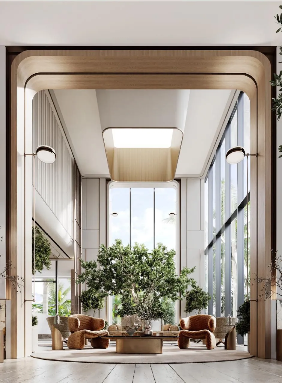 Double-height lobby lounge with full-height glazing and indoor trees